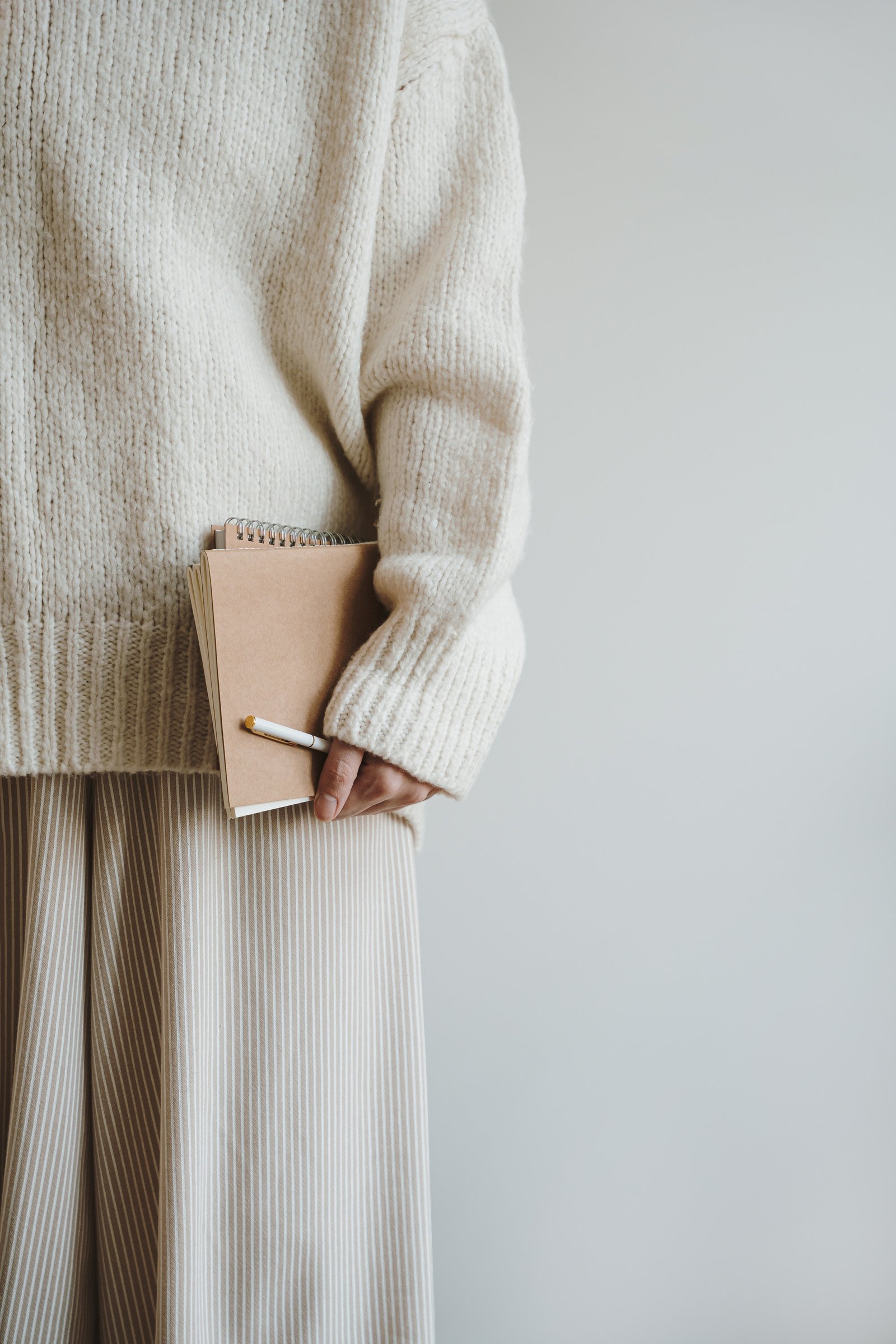 Person Holding Pen and Notebook